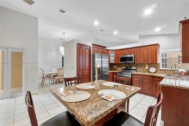 a kitchen with granite countertop a sink and stove