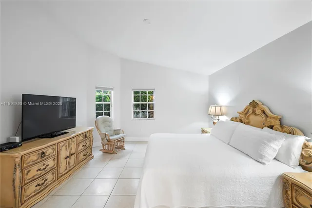 a bedroom with furniture and flat screen tv