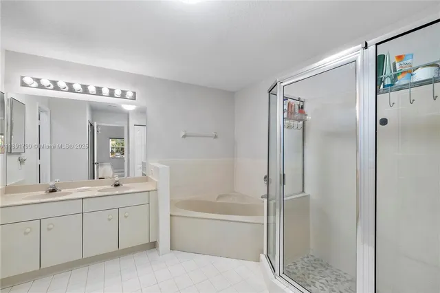a spacious bathroom with a shower a sink and mirror