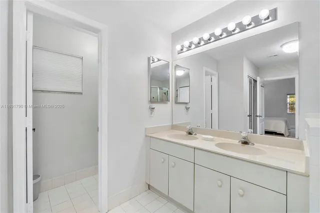 a bathroom with a double vanity sink and a mirror