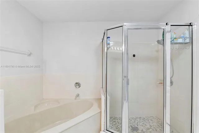 a bathroom with a bathtub and shower