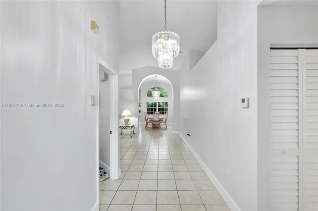 a view of living room with a chandelier fan and wooden floor