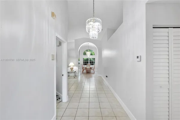 a view of living room with a chandelier fan and wooden floor