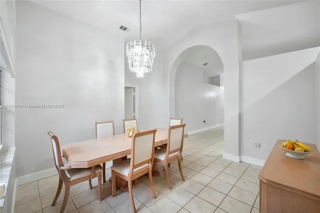 a view of a dining room with furniture and chandelier