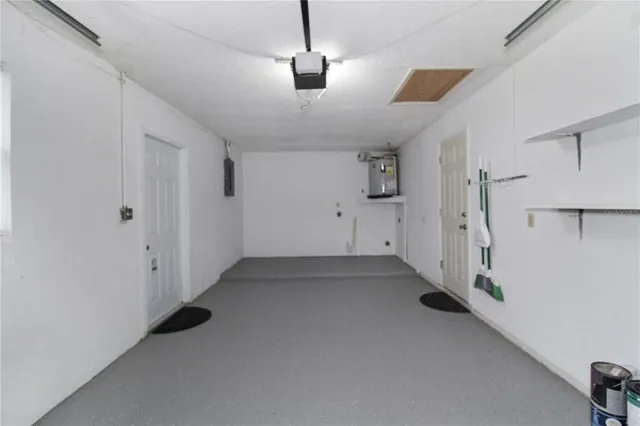 an empty room with a ceiling fan and window