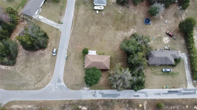 an aerial view of a house with a yard and a fountain