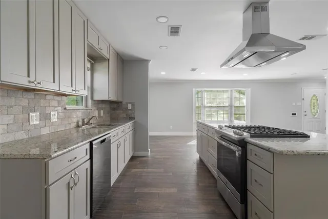 a kitchen with stainless steel appliances granite countertop a stove and a sink
