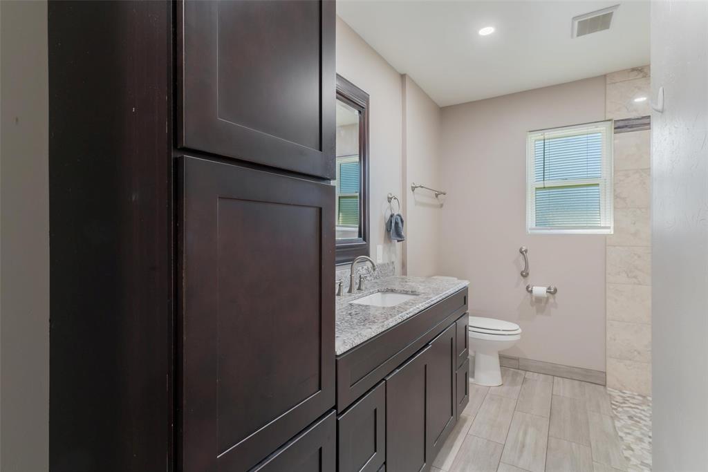 8461 Hunnicut Road Dallas, TX 75228 - Photo 19 of 30 a bathroom with a granite countertop sink toilet and shower curtains