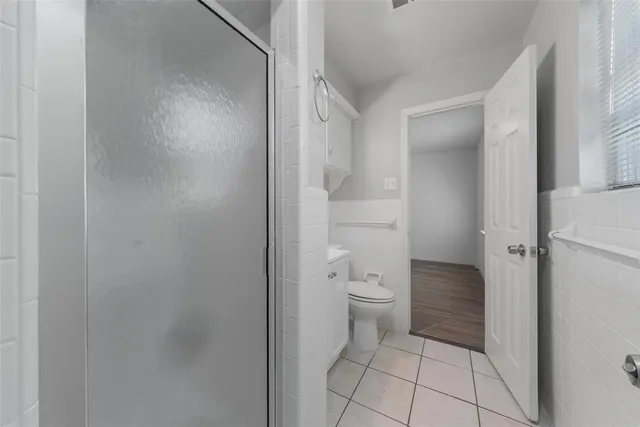 a bathroom with a toilet and a shower