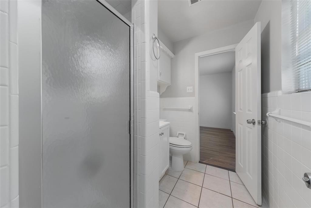 8461 Hunnicut Road Dallas, TX 75228 - Photo 22 of 30 a bathroom with a toilet and a shower