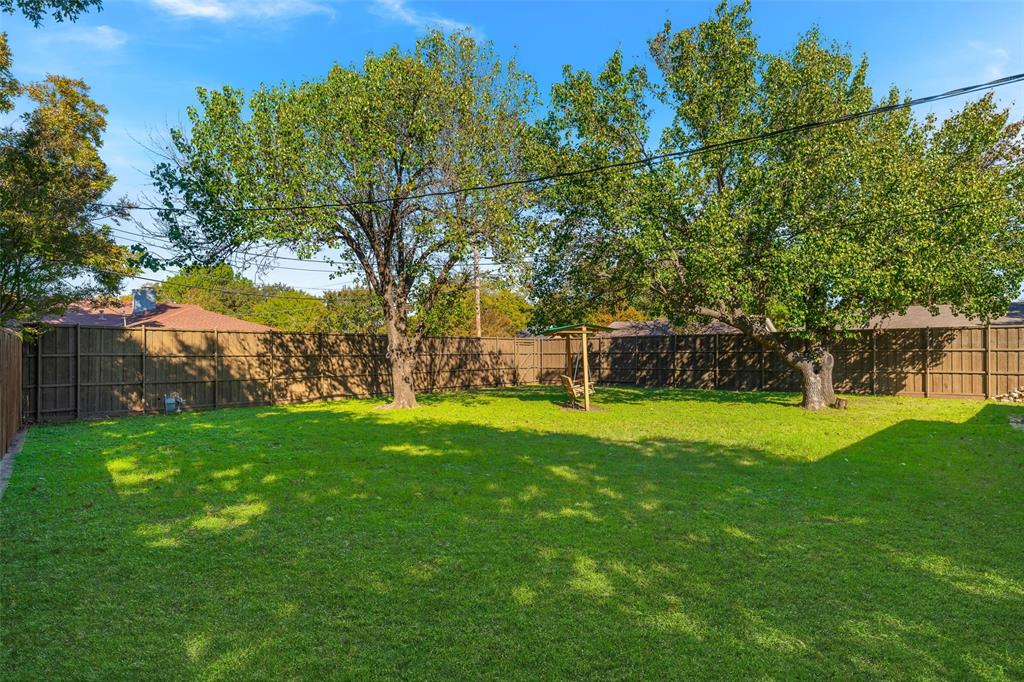 8461 Hunnicut Road Dallas, TX 75228 - Photo 30 of 30 a view of a backyard with large trees