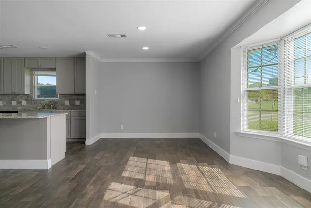 a view of a kitchen with a sink dishwasher and wooden floor