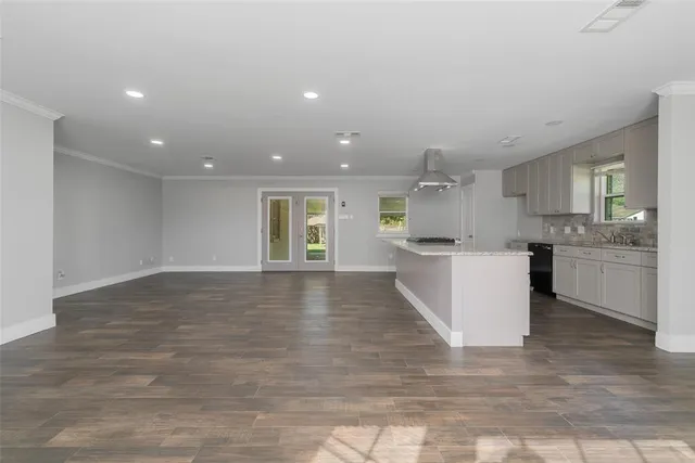 a view of kitchen with kitchen island and stainless steel appliances