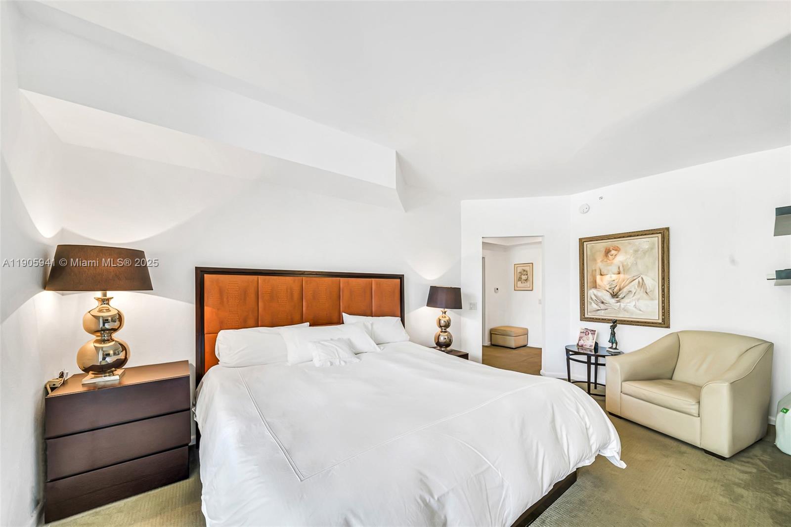 21050 Point Place, Unit 401 Aventura, FL 33180 - Photo 12 of 40 a bedroom with a bed and lamp