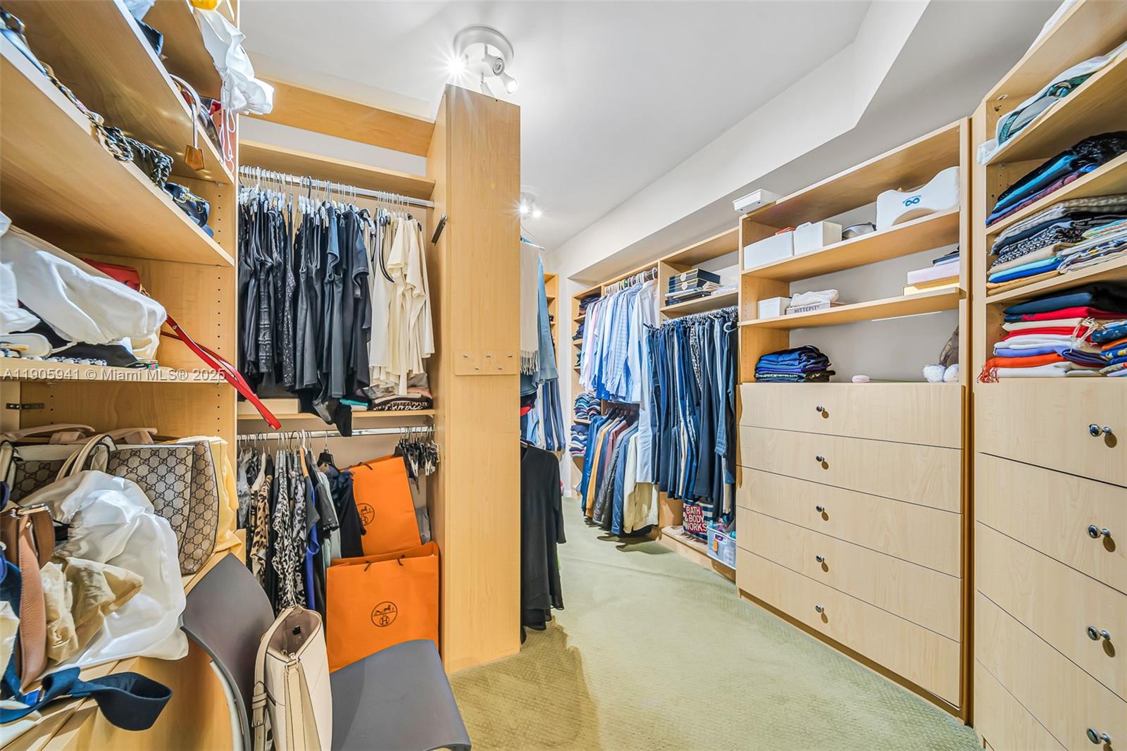 21050 Point Place, Unit 401 Aventura, FL 33180 - Photo 14 of 40 a view of walk in closet with clothes and shoes