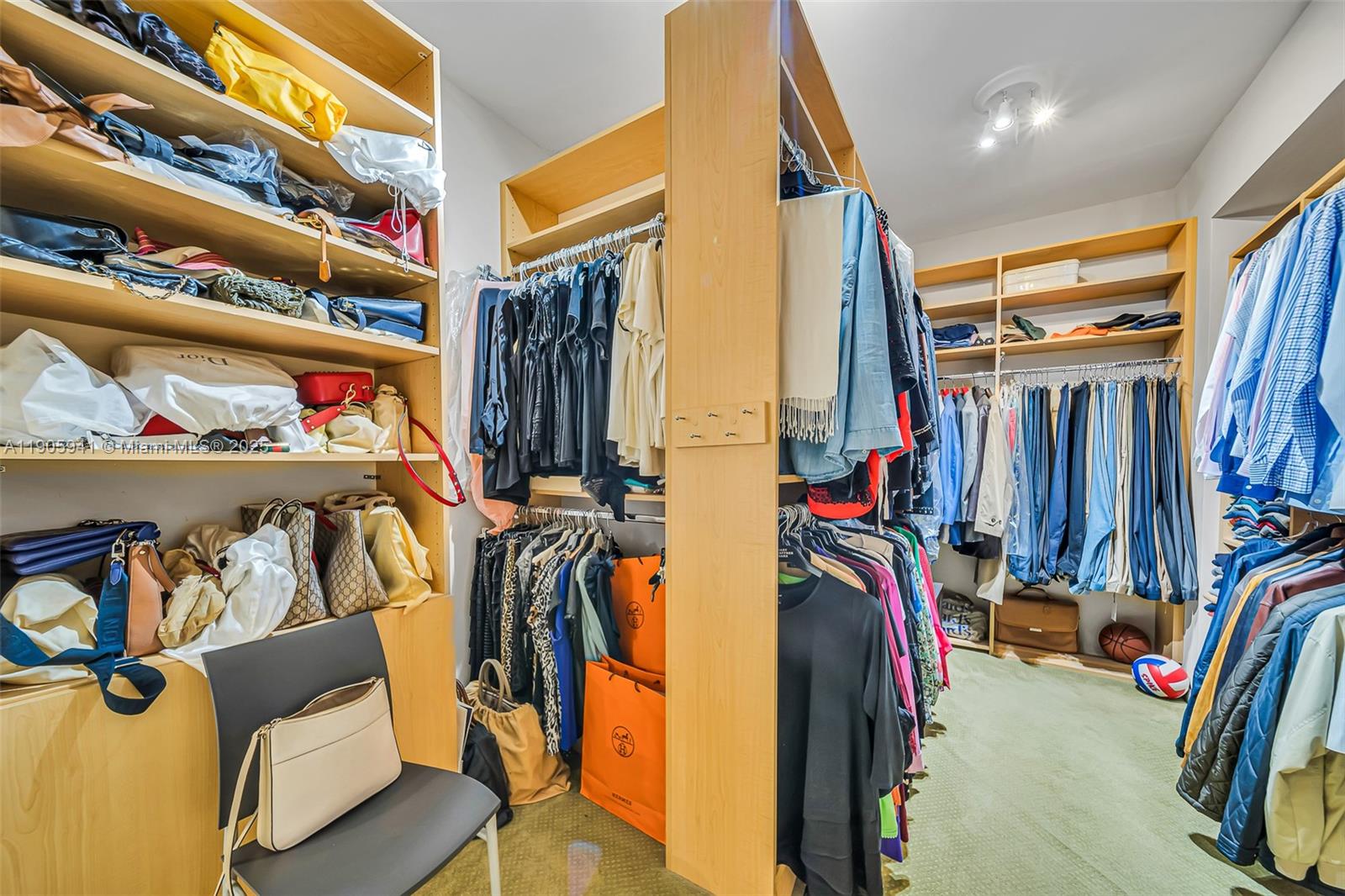 21050 Point Place, Unit 401 Aventura, FL 33180 - Photo 15 of 40 a view of walk in closet with clothes and shoes