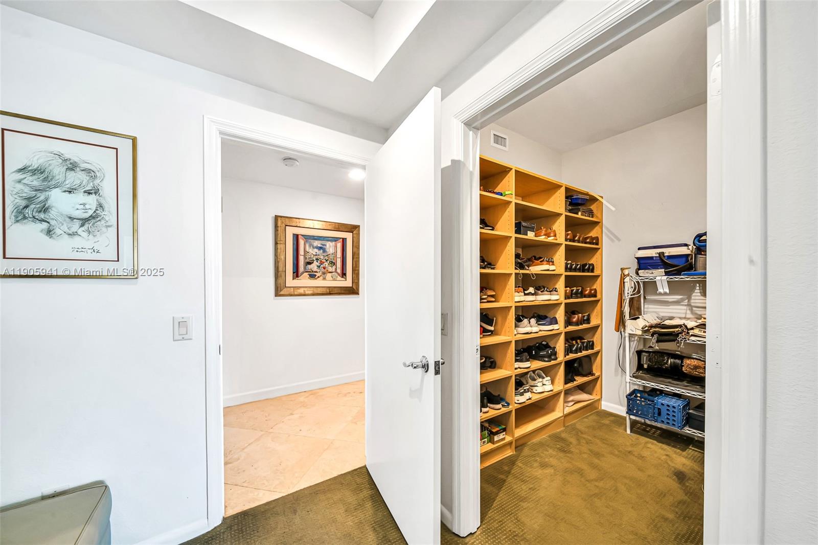 21050 Point Place, Unit 401 Aventura, FL 33180 - Photo 16 of 40 a view of walk in closet with empty racks