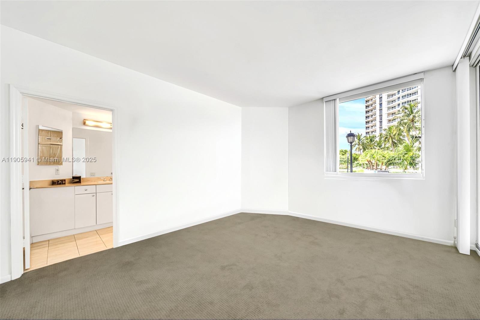 21050 Point Place, Unit 401 Aventura, FL 33180 - Photo 18 of 40 an empty room with windows