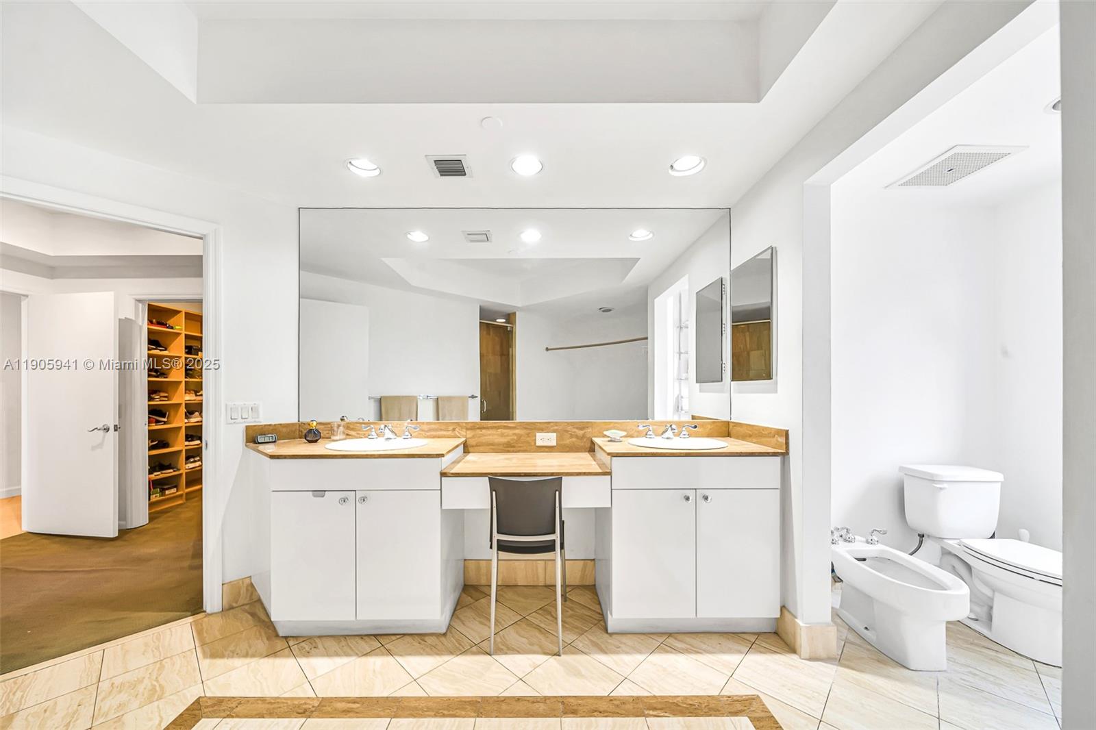 21050 Point Place, Unit 401 Aventura, FL 33180 - Photo 19 of 40 a kitchen with a sink and chairs