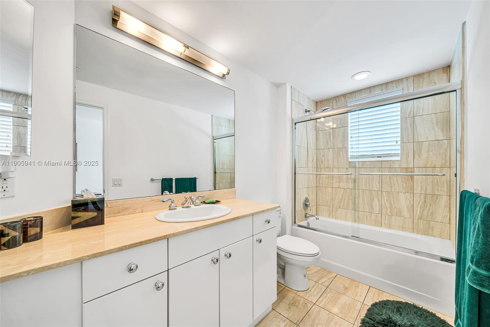 21050 Point Place, Unit 401 Aventura, FL 33180 - Photo 20 of 40 a bathroom with a granite countertop sink toilet and shower