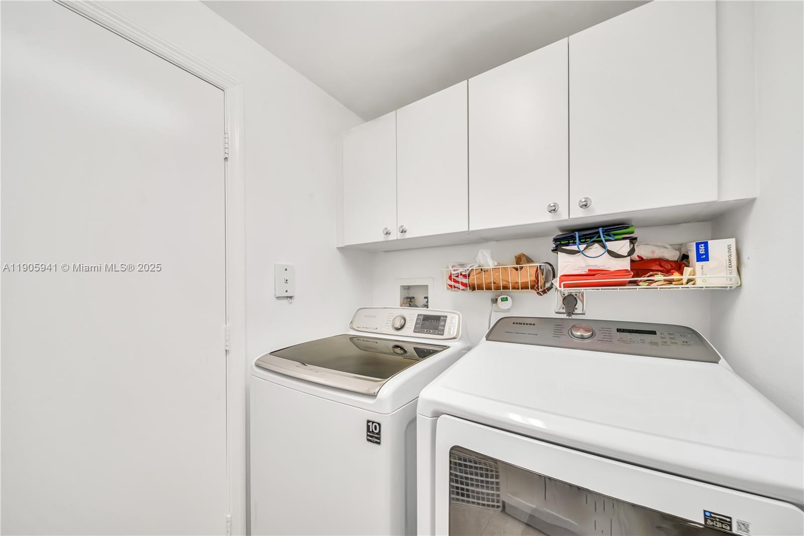 21050 Point Place, Unit 401 Aventura, FL 33180 - Photo 25 of 40 a utility room with dryer and washer