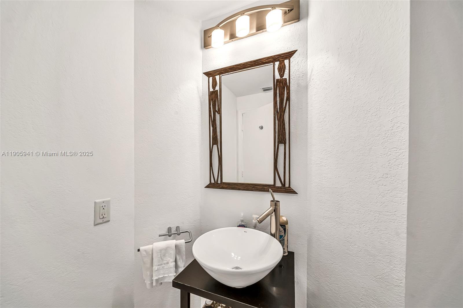 21050 Point Place, Unit 401 Aventura, FL 33180 - Photo 26 of 40 a bathroom with a sink a mirror and a toilet