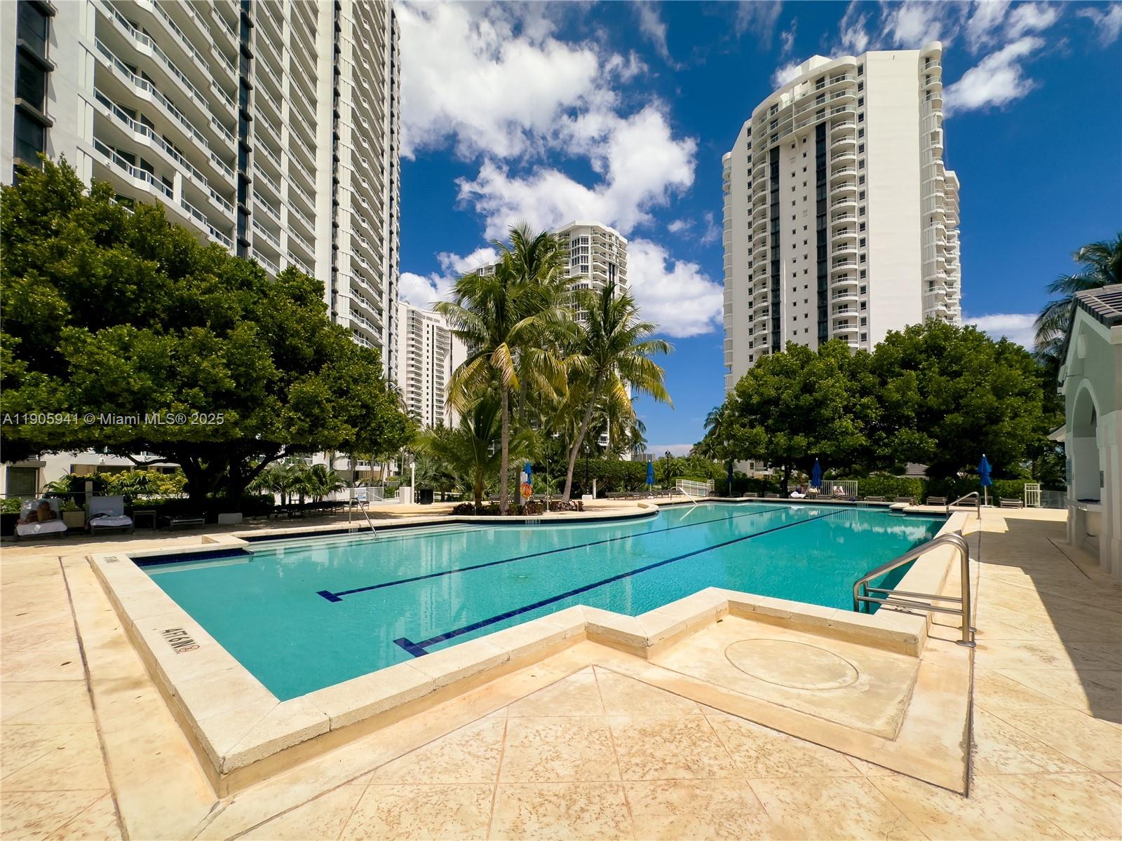 21050 Point Place, Unit 401 Aventura, FL 33180 - Photo 31 of 40 a view of a swimming pool and a yard
