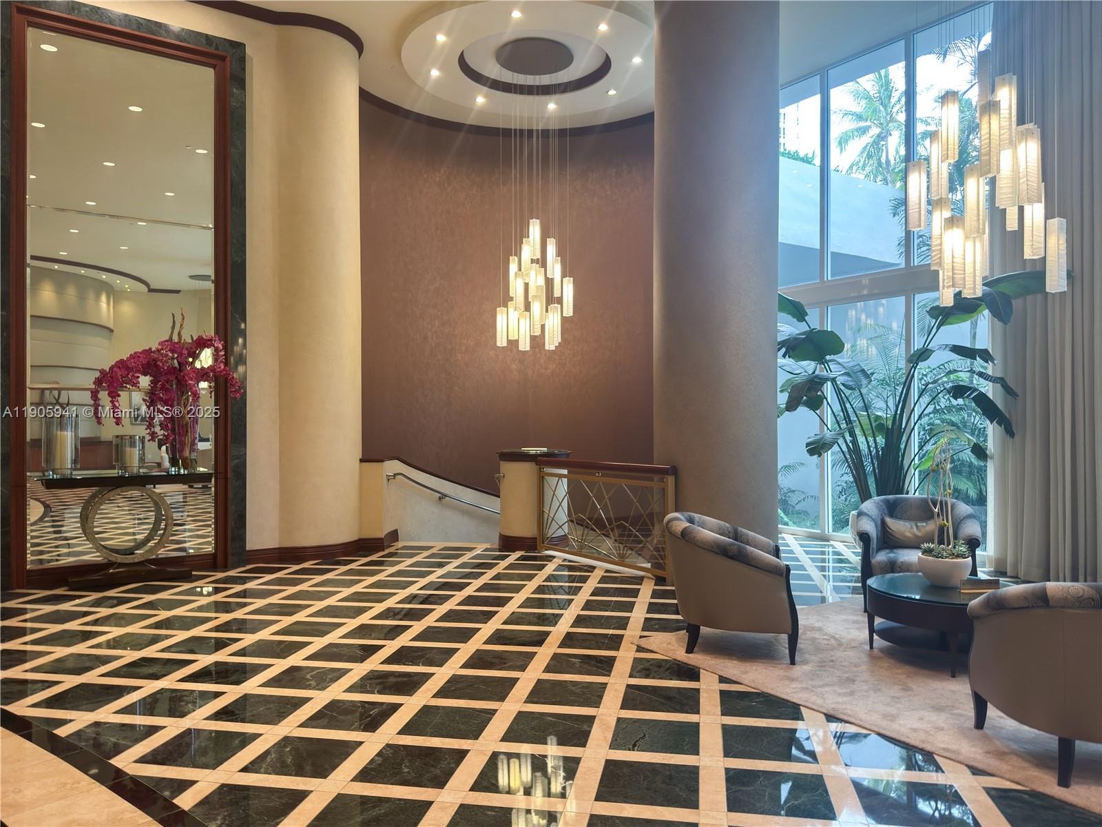 21050 Point Place, Unit 401 Aventura, FL 33180 - Photo 37 of 40 a bedroom with a bed and a potted plant