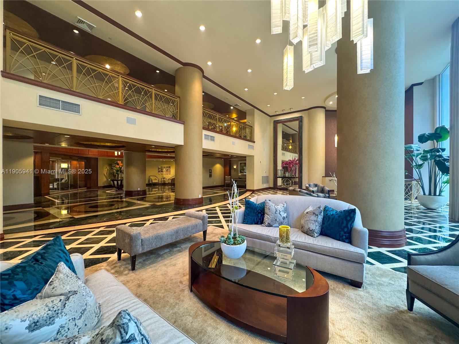 21050 Point Place, Unit 401 Aventura, FL 33180 - Photo 38 of 40 a living room with furniture and a large window