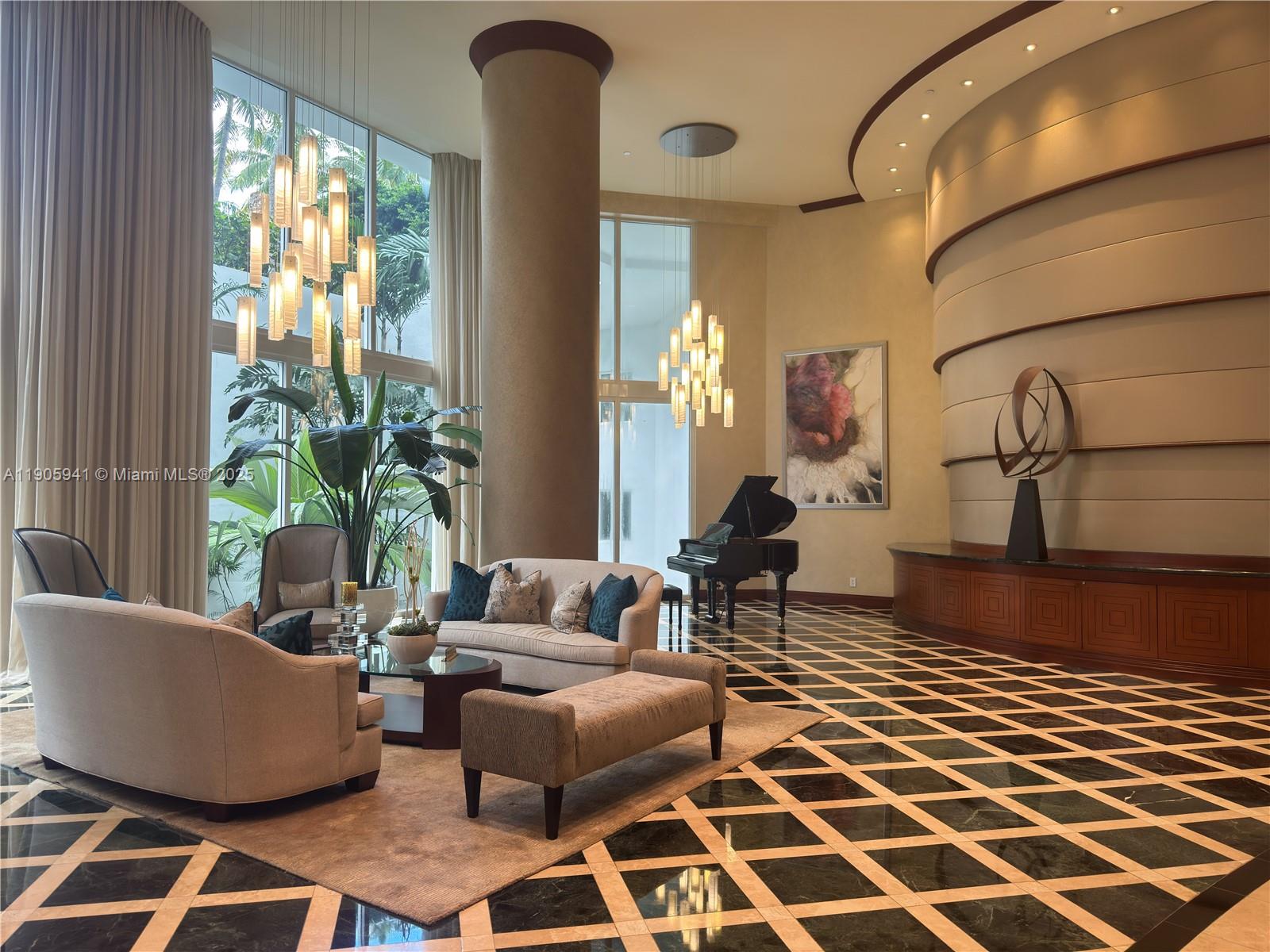 21050 Point Place, Unit 401 Aventura, FL 33180 - Photo 40 of 40 a living room with furniture and a floor to ceiling window