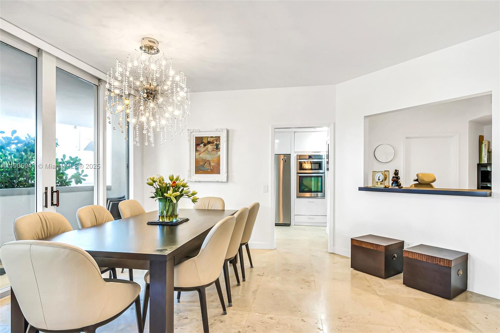 21050 Point Place, Unit 401 Aventura, FL 33180 - Photo 4 of 40 a view of a dining room with furniture and chandelier