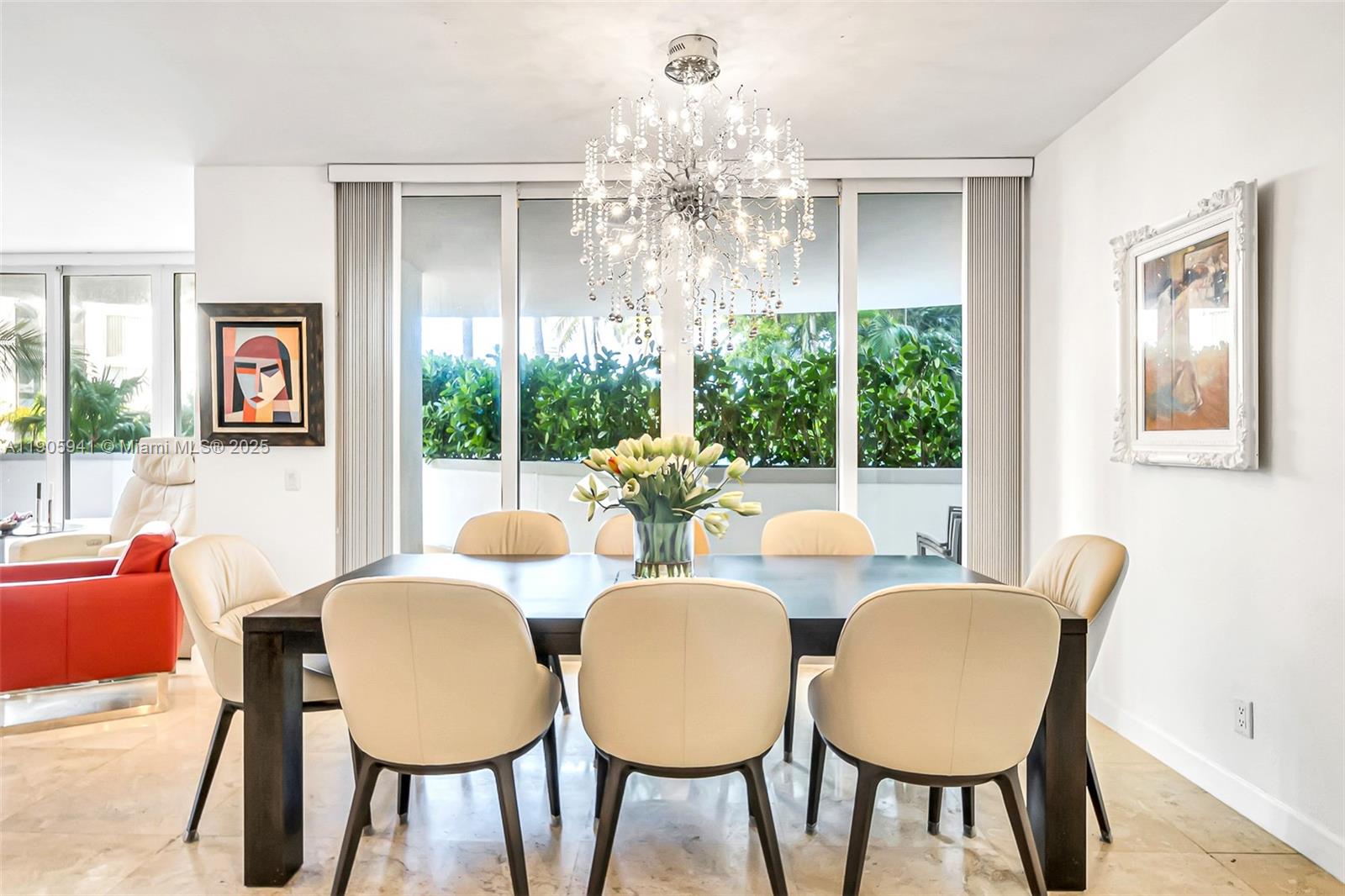 21050 Point Place, Unit 401 Aventura, FL 33180 - Photo 5 of 40 a dining room with furniture a chandelier and wooden floor