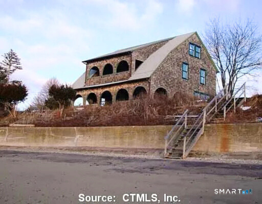 Undisclosed Address Madison, CT 06443 - Photo 1 of 1 a front view of a house with a yard