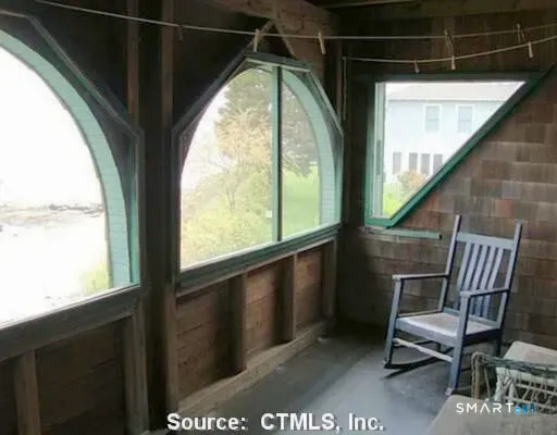 a view of a chair and table in the balcony