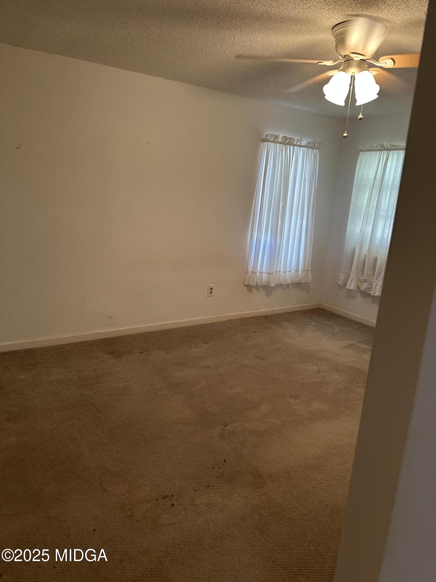 362 Old Macon Road Gray, GA 31032 - Photo 14 of 23 an empty room with windows and fan