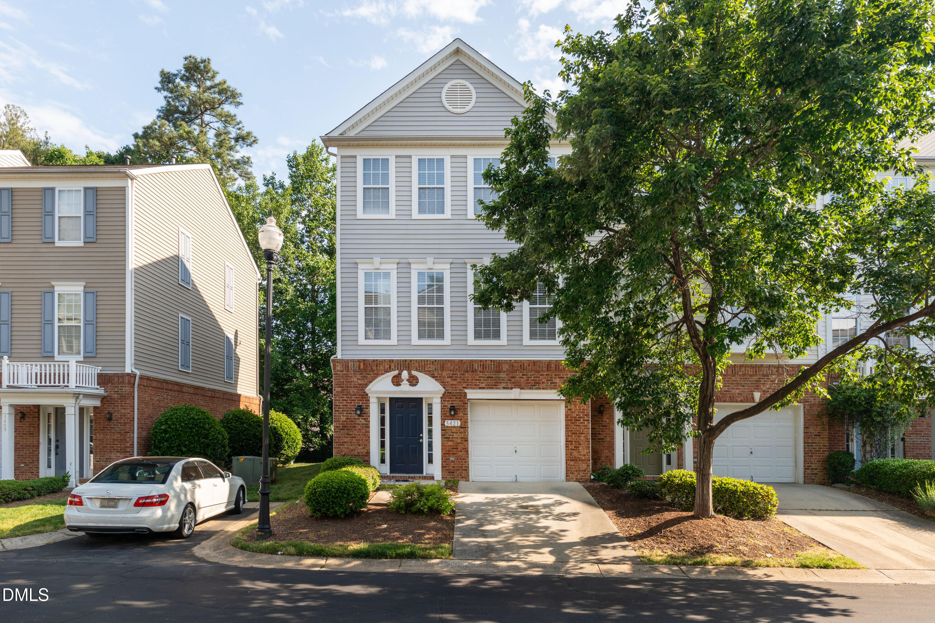 5421 Golden Arrow Lane Raleigh, NC 27613 - Photo 2 of 49 a front view of a house with a yard and garage