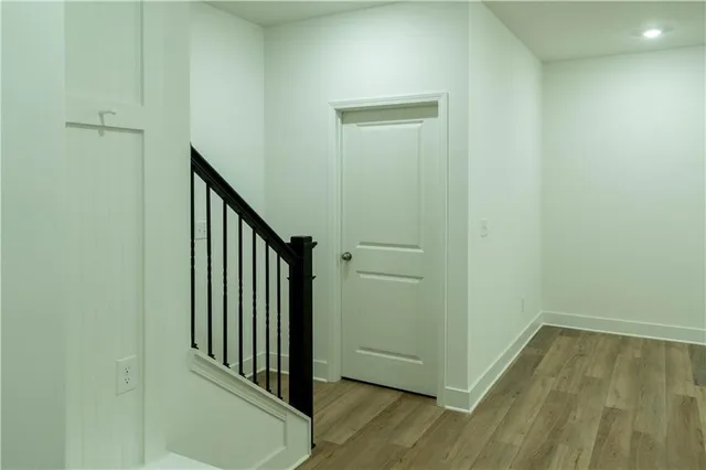 a view of a hallway with wooden floor
