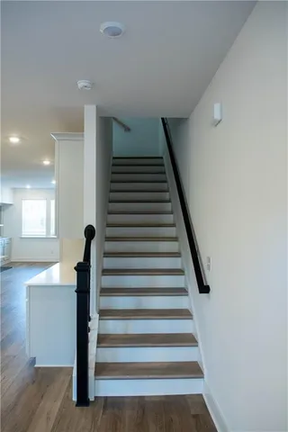 a view of entryway and hall with wooden floor