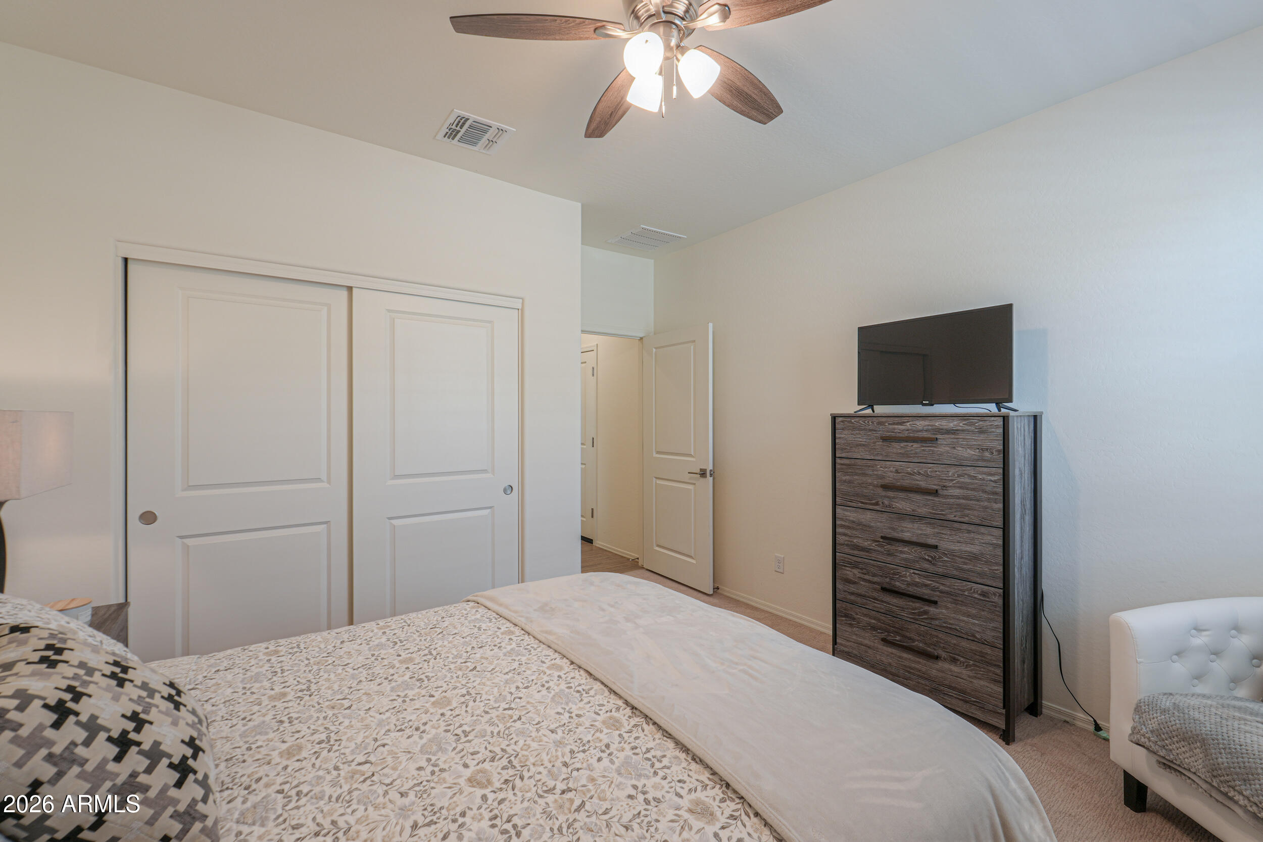 42085 West Cribbage Road Maricopa, AZ 85138 - Photo 18 of 35 a bedroom with a bed and a television