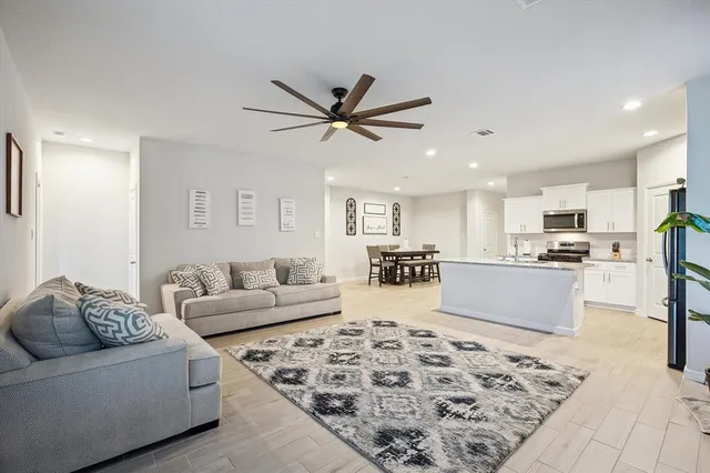 a living room with furniture and kitchen view