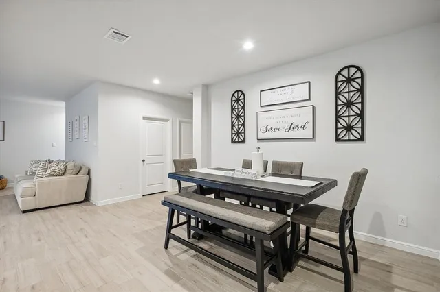 a view of a dining room with furniture and wooden floor