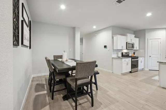 a view of a dining room with furniture and wooden floor