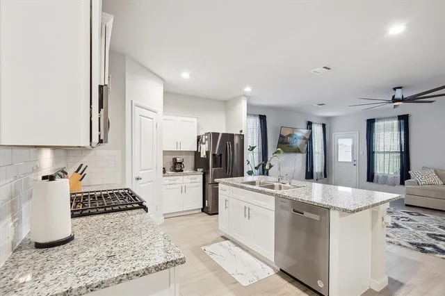 a kitchen with sink and refrigerator