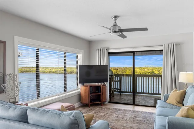 a living room with furniture tv and a window