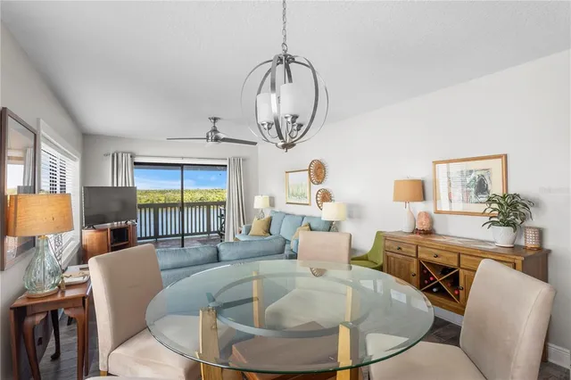 a living room with furniture a window and a chandelier
