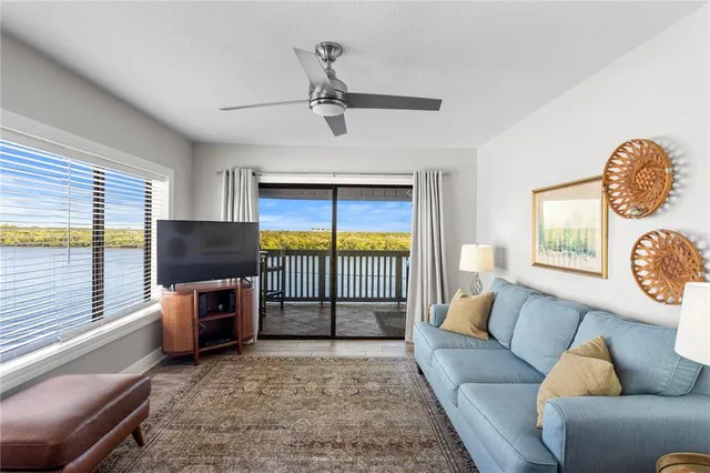 a living room with fireplace furniture and a flat screen tv