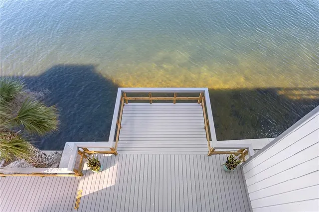 a bedroom with a large bed a flat tv screen and dresser