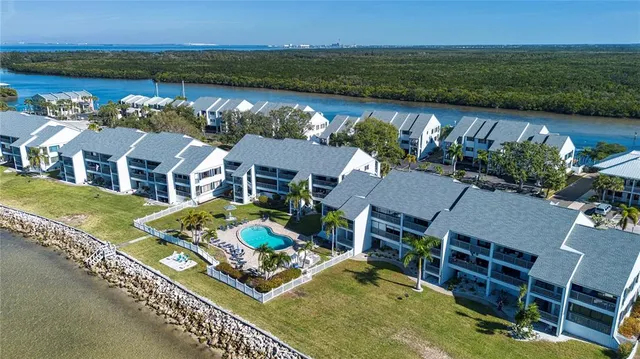 an aerial view of residential houses with outdoor space and seating