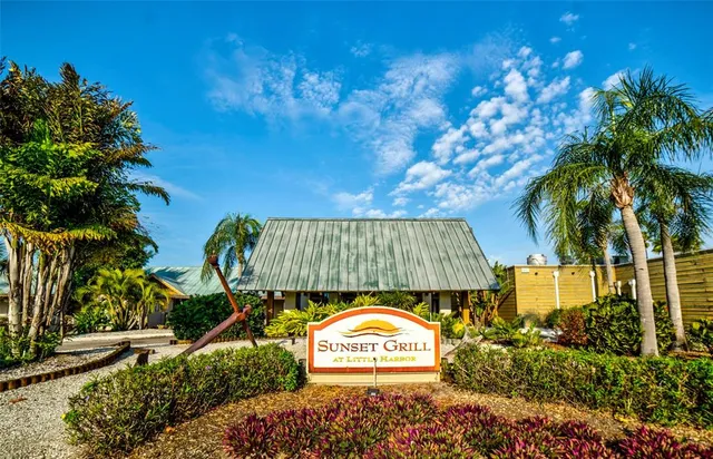 a outdoor space with lots of tables a chairs and a barbeque