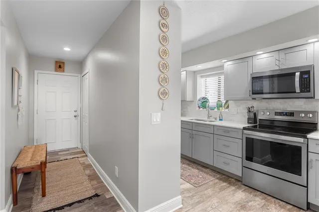 a kitchen with stainless steel appliances granite countertop a refrigerator and a stove top oven